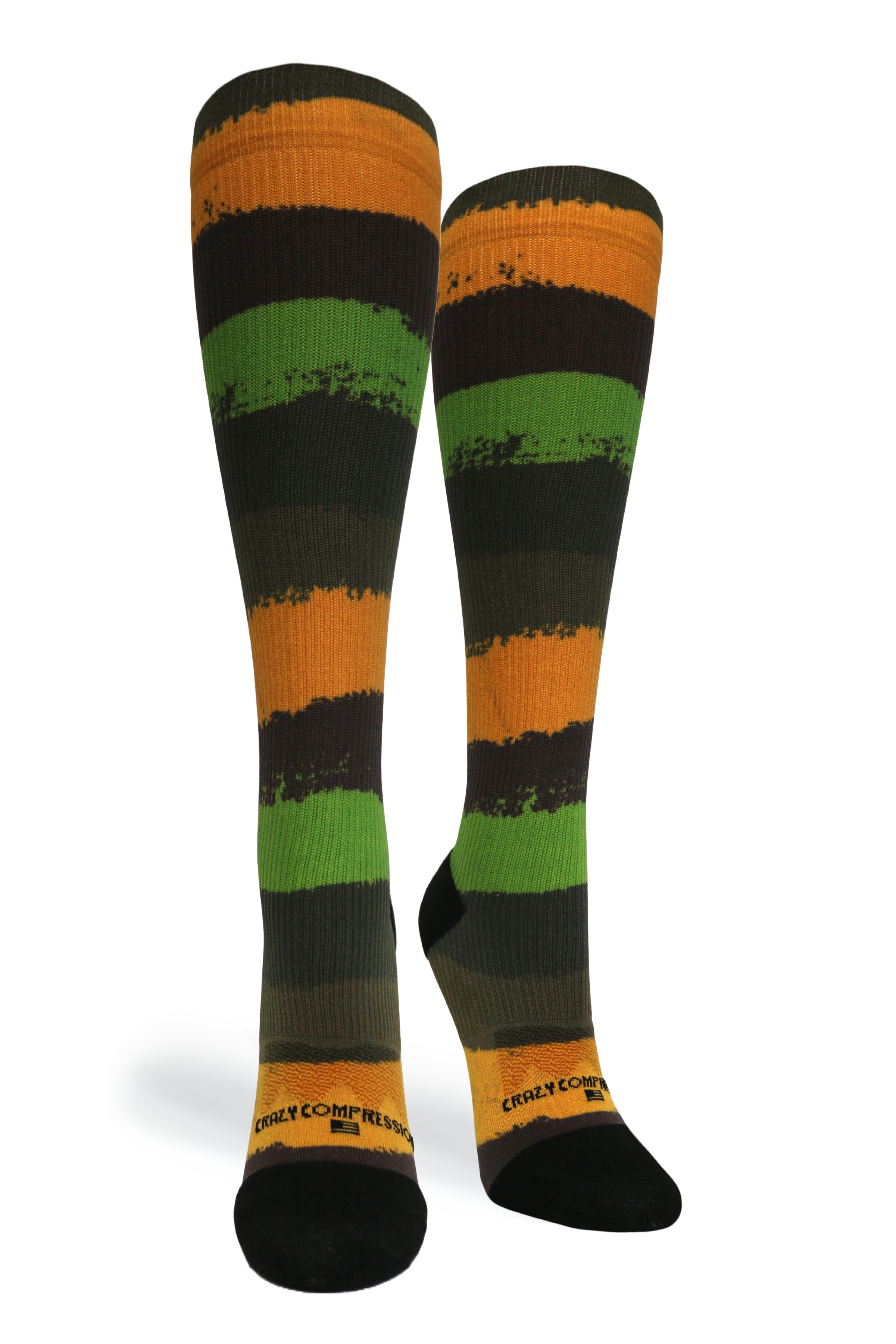 A pair of compression socks with horizontal stripes in green, orange, and black colors.