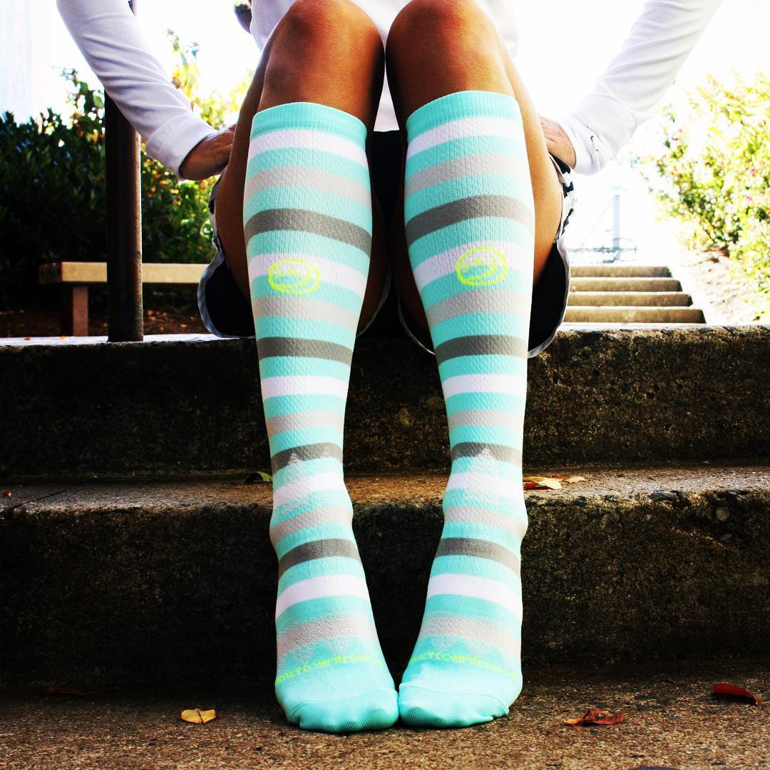 Person wearing knee high, blue, striped socks